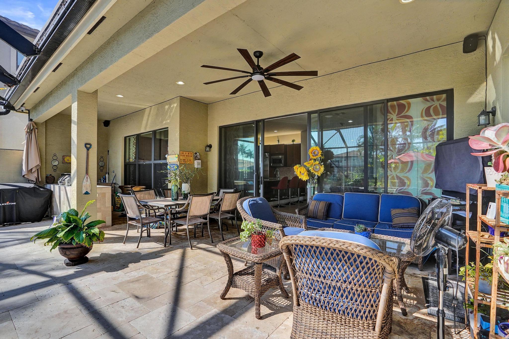 16610 Gateway Bridge Drive Delray Beach, FL 33446 - Photo 38 of 67 a living room with furniture a chandelier and a floor to ceiling window