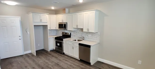 a kitchen with a stove and a refrigerator