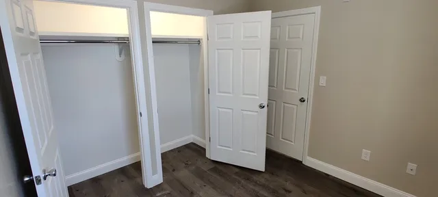 a view of a room with wooden floor and sliding door