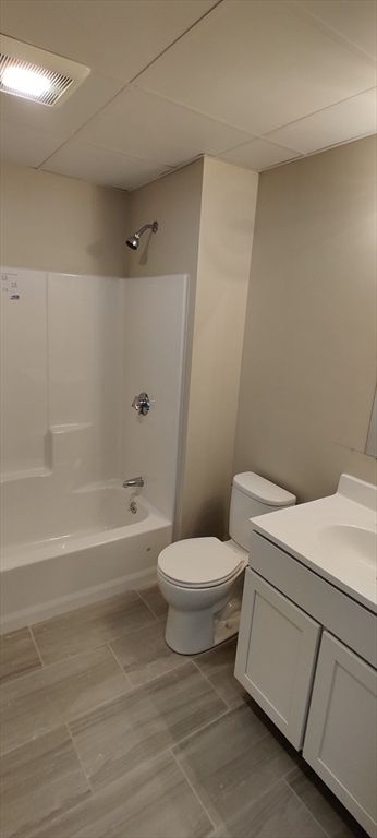 191 North Common Street, Unit 207 Lynn, MA 01905 - Photo 7 of 8 a white toilet sitting next to a bath tub