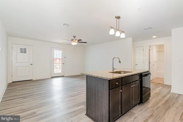 a kitchen with a sink and chandelier