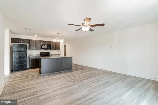 a view of kitchen with wooden floor and window