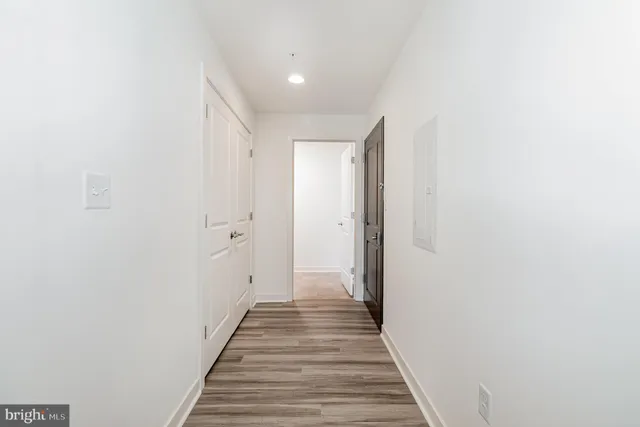 a view of a hallway with wooden floor