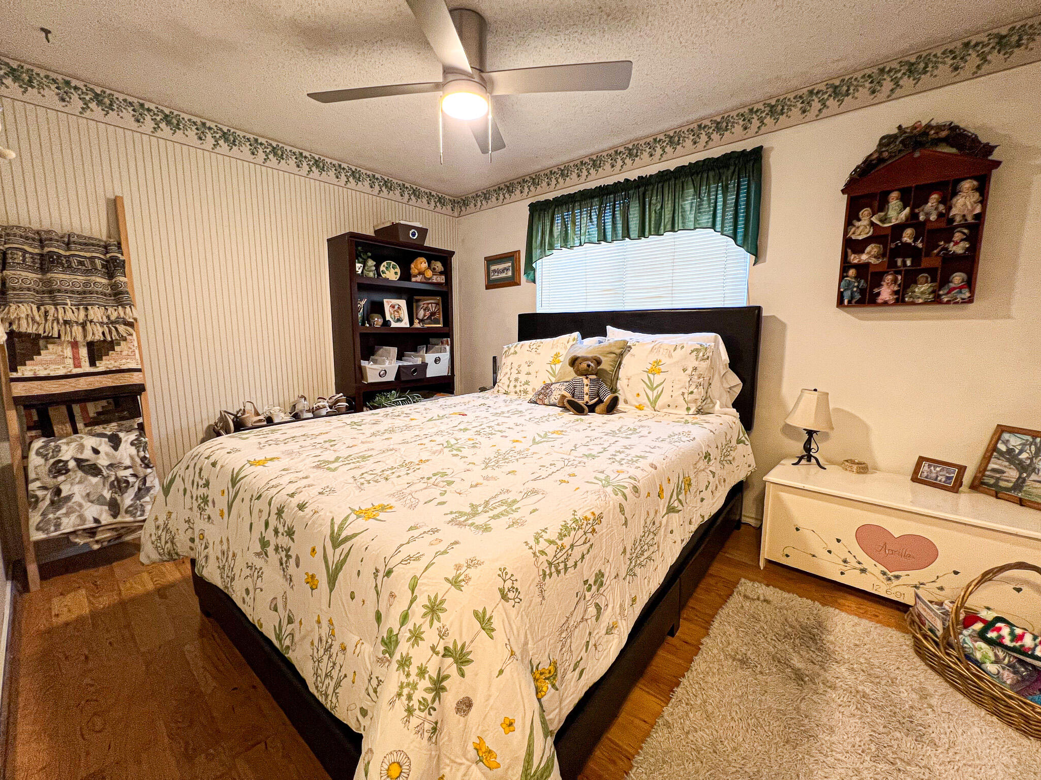 1225 East B Street Fossil, OR 97830 - Photo 15 of 33 a large bed sitting in a bedroom next to a window and a chandelier