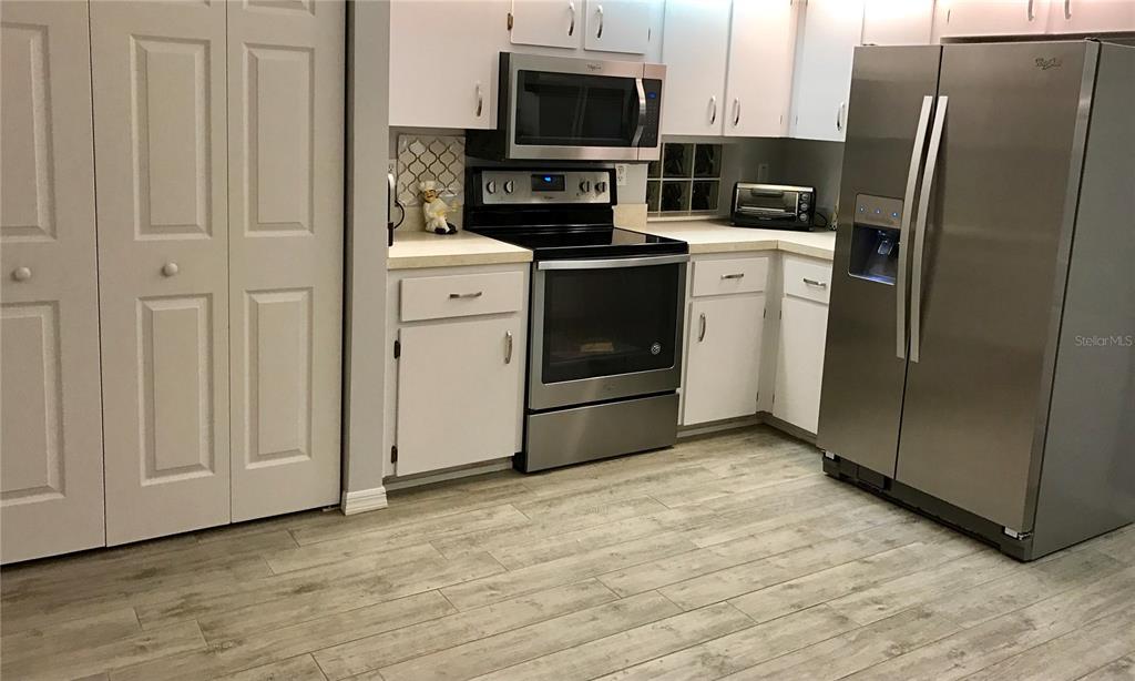 10990 Southwest 69th Circle Ocala, FL 34476 - Photo 1 of 1 a kitchen with stainless steel appliances a refrigerator stove and sink
