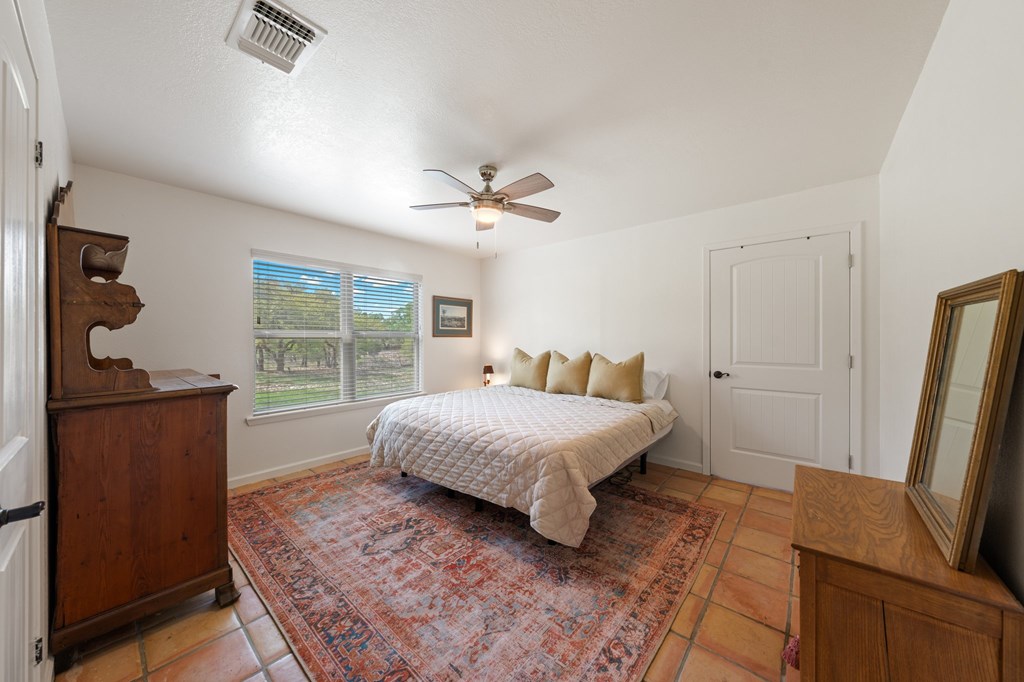 563 J J B Road Harper, TX 78631 - Photo 12 of 40 a bedroom with a bed window and a dresser