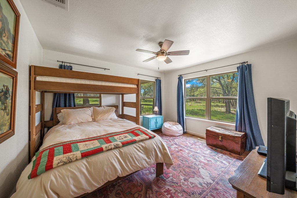 563 J J B Road Harper, TX 78631 - Photo 13 of 40 a bedroom with a bed and a large window with outer view