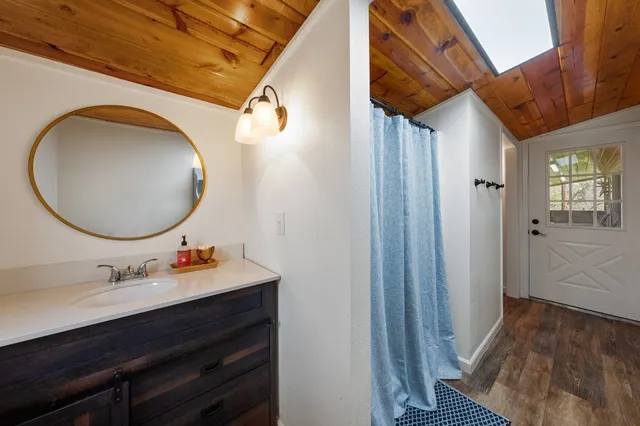 a bathroom with a sink mirror and vanity
