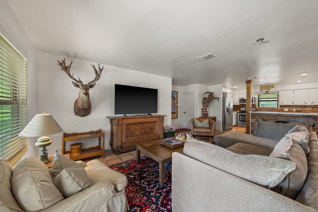 563 J J B Road Harper, TX 78631 - Photo 5 of 40 a living room with furniture and a flat screen tv