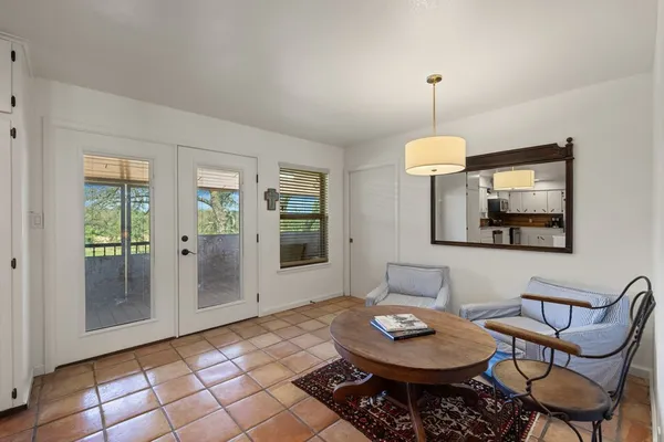 a living room with furniture a window and a table