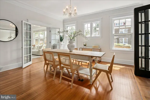 a large kitchen with granite countertop a stove a sink a dining table and chairs