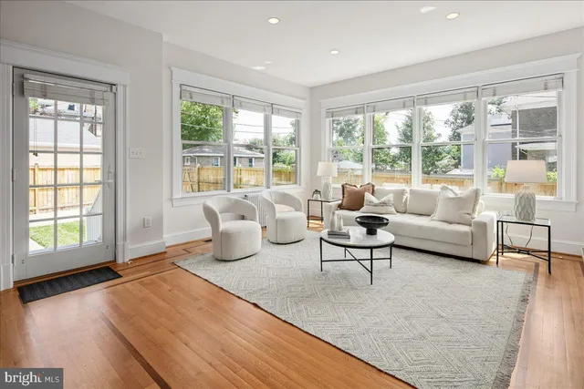 a kitchen with stainless steel appliances granite countertop wooden cabinets a stove top oven a sink and dishwasher with wooden floor