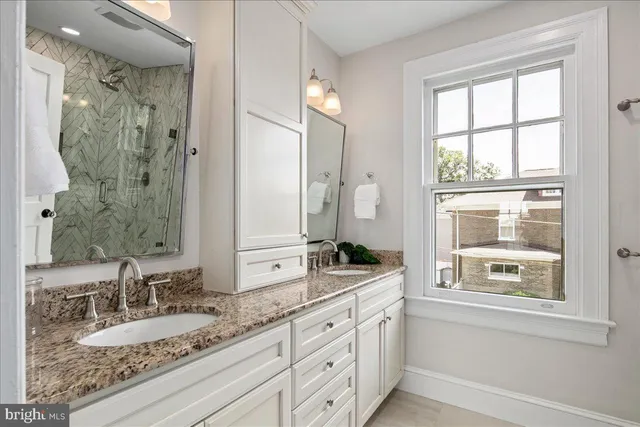 a kitchen with stainless steel appliances granite countertop a stove a sink dishwasher a refrigerator and a microwave oven with wooden floor