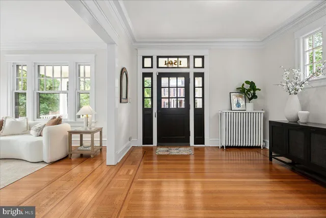 a living room with furniture windows and wooden floor