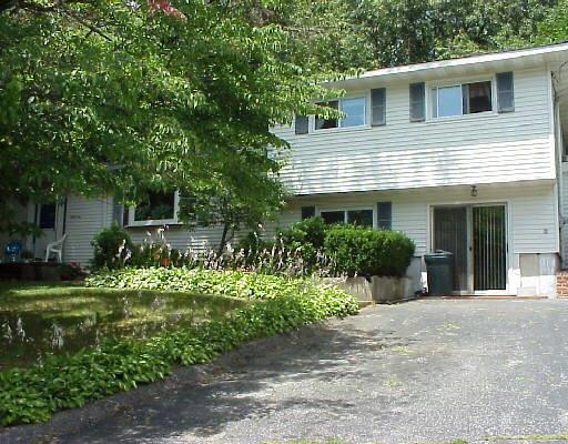39 Mohawk Drive Norwalk, CT 06851 - Photo 1 of 1 a front view of a house with a yard