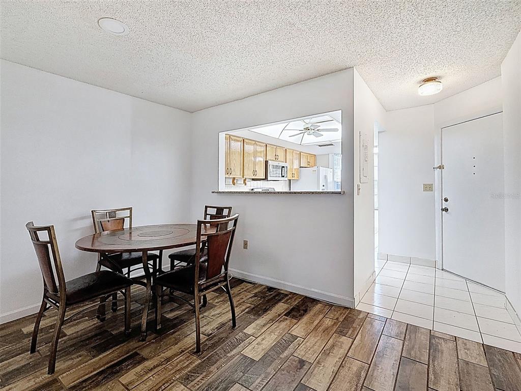 11403 Versailles Lane, Unit E Port Richey, FL 34668 - Photo 11 of 74 a view of a dining room with furniture and wooden floor