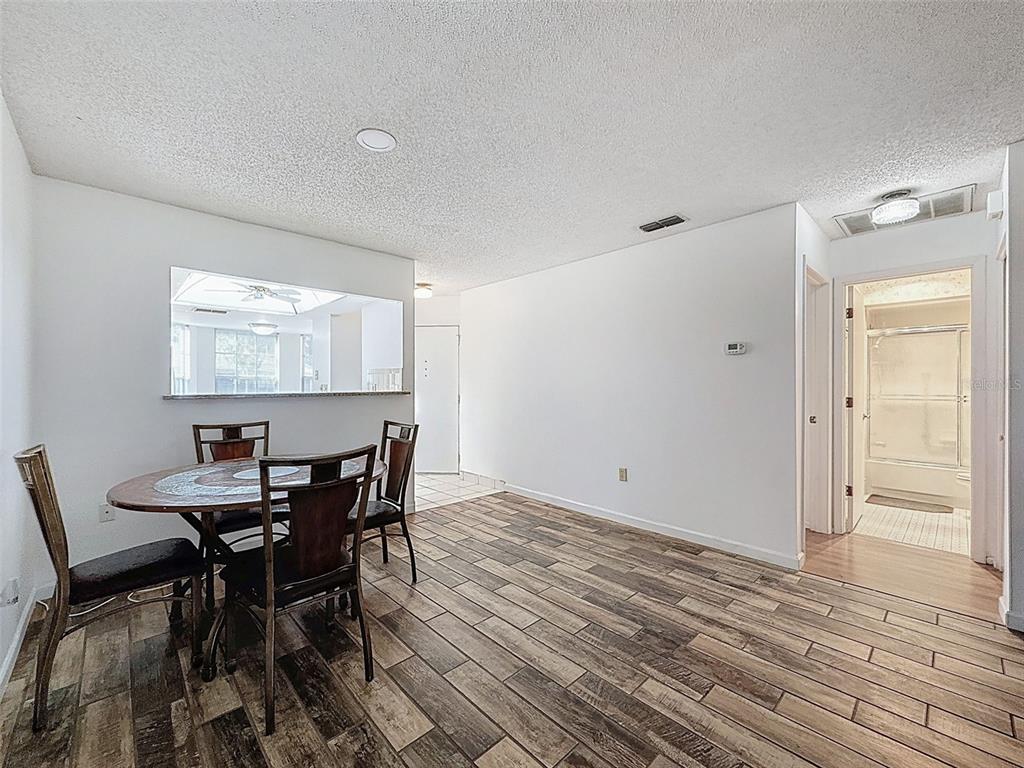 11403 Versailles Lane, Unit E Port Richey, FL 34668 - Photo 13 of 74 a view of a dining room with furniture and window