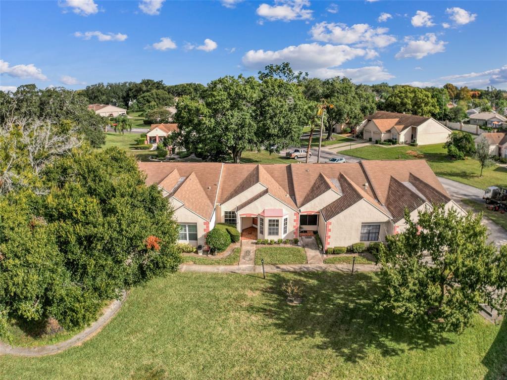 11403 Versailles Lane, Unit E Port Richey, FL 34668 - Photo 14 of 74 a view of a house with a big yard