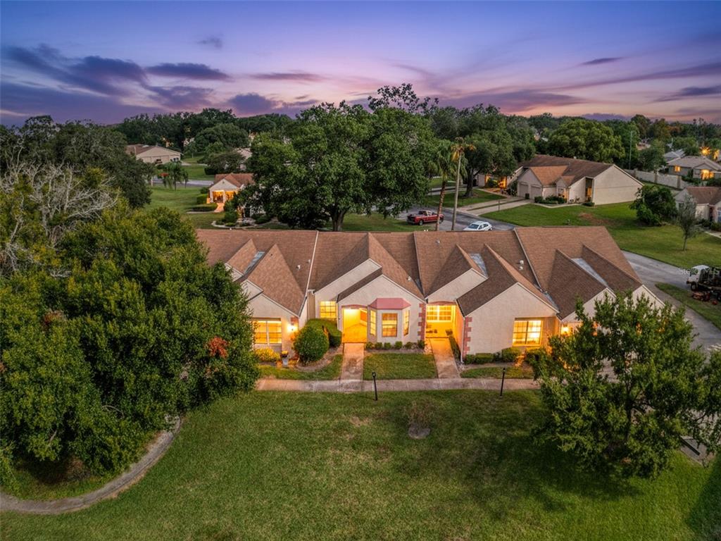 11403 Versailles Lane, Unit E Port Richey, FL 34668 - Photo 16 of 74 a view of a house with a yard