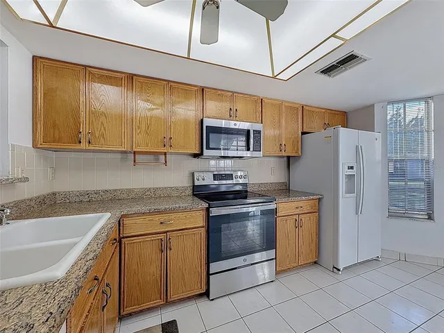 a kitchen with stainless steel appliances granite countertop a sink and cabinets