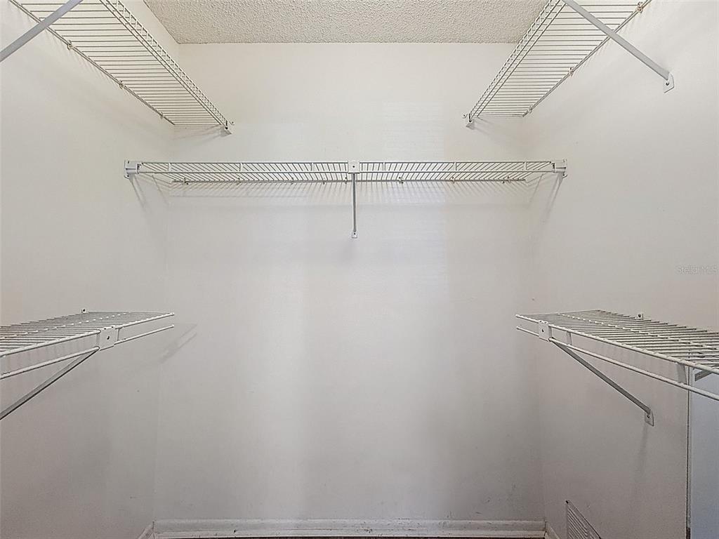 11403 Versailles Lane, Unit E Port Richey, FL 34668 - Photo 24 of 74 a view of a room with racks on the wall