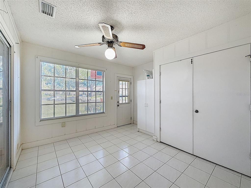 11403 Versailles Lane, Unit E Port Richey, FL 34668 - Photo 26 of 74 a view of an empty room with a window