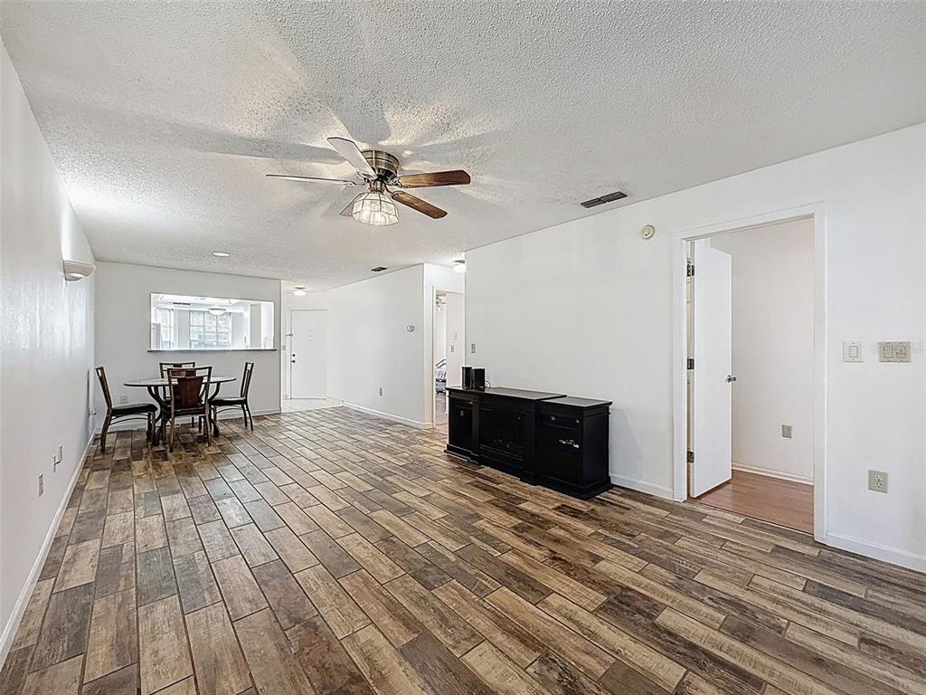 11403 Versailles Lane, Unit E Port Richey, FL 34668 - Photo 3 of 74 a view of a livingroom with furniture and wooden floor