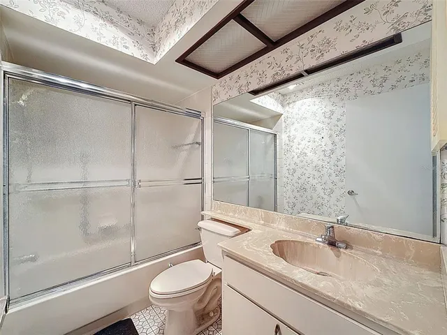 a bedroom with a bed and a ceiling fan