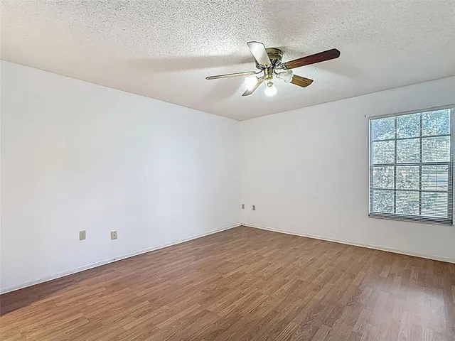 an empty room with wooden floor and closet