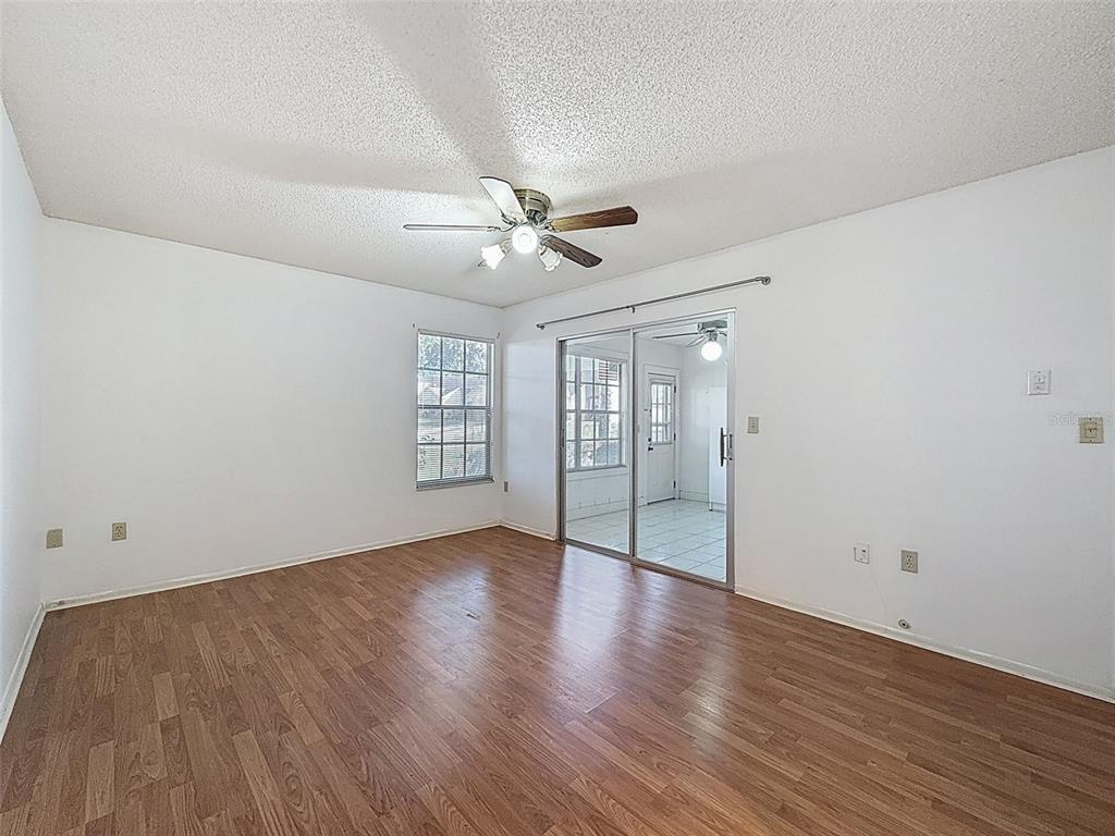 11403 Versailles Lane, Unit E Port Richey, FL 34668 - Photo 38 of 74 wooden floor in an empty room with a window