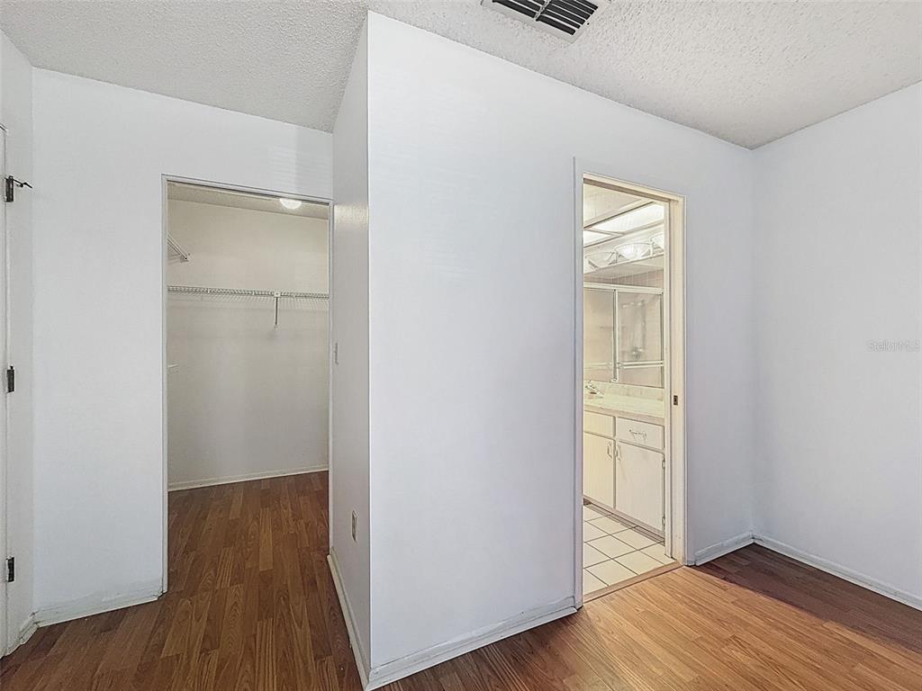 11403 Versailles Lane, Unit E Port Richey, FL 34668 - Photo 39 of 74 an empty room with wooden floor and closet