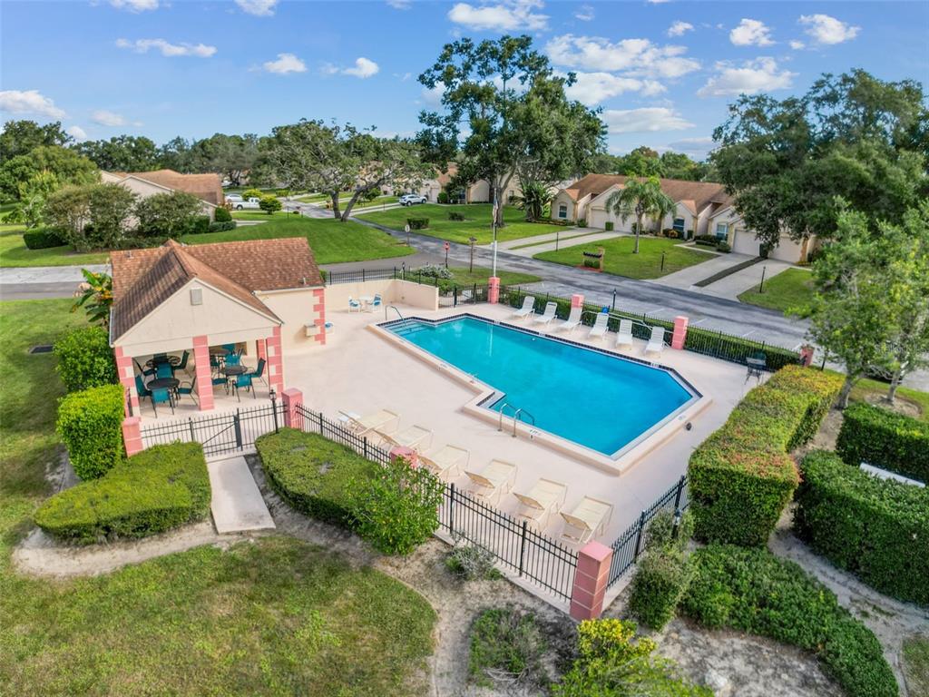 11403 Versailles Lane, Unit E Port Richey, FL 34668 - Photo 42 of 74 an aerial view of a house with a garden and lake view