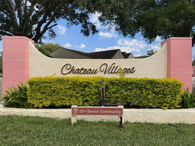 a view of backyard of house with green space