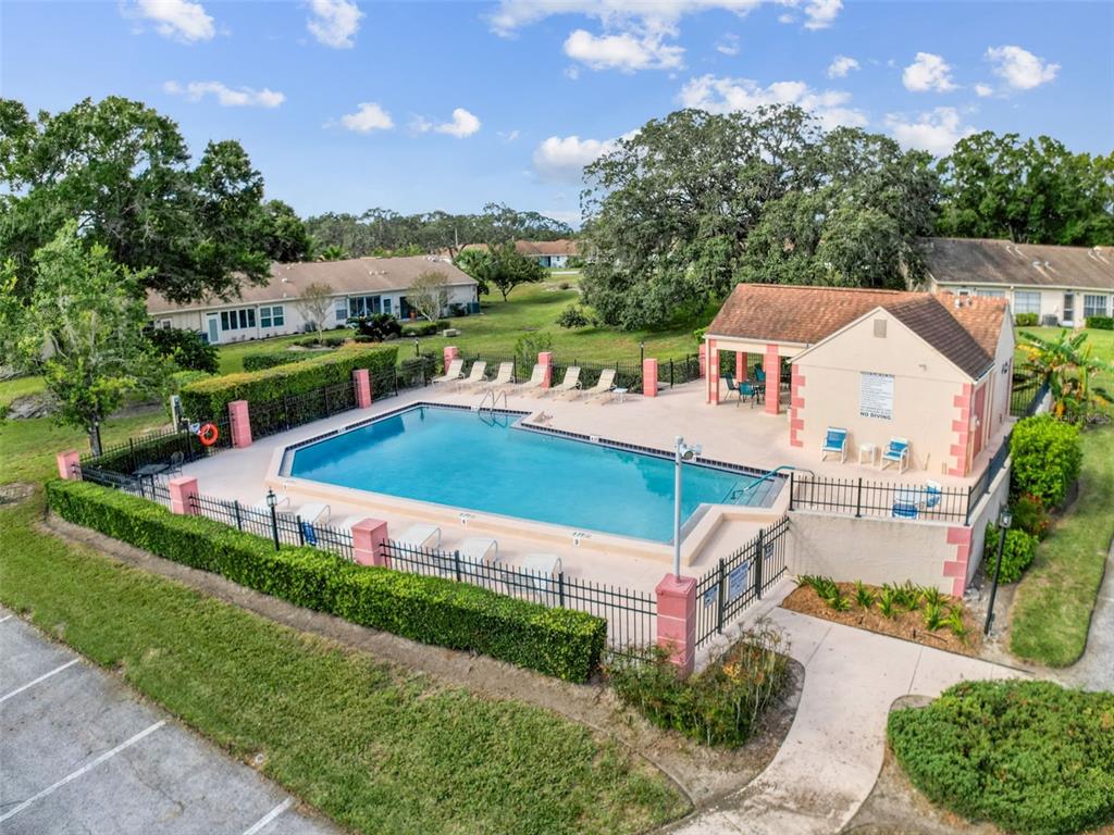 11403 Versailles Lane, Unit E Port Richey, FL 34668 - Photo 50 of 74 an aerial view of a house with a garden and swimming pool