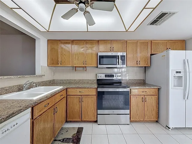 a kitchen with stainless steel appliances granite countertop a sink and cabinets