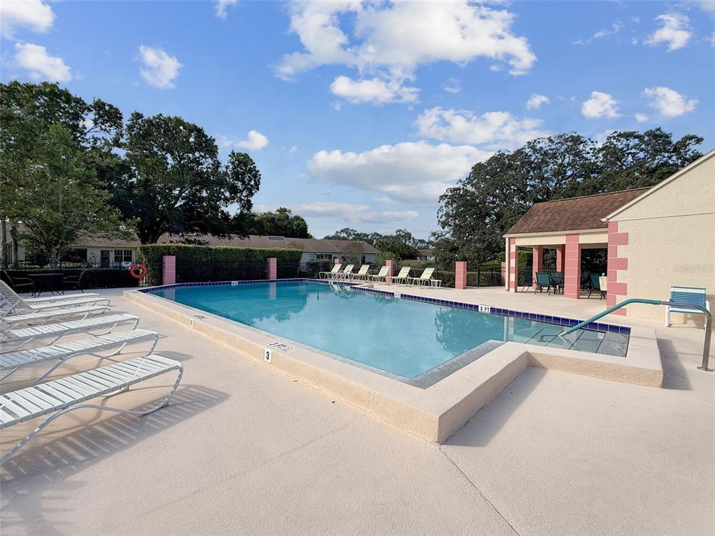 11403 Versailles Lane, Unit E Port Richey, FL 34668 - Photo 52 of 74 a view of a house with a yard