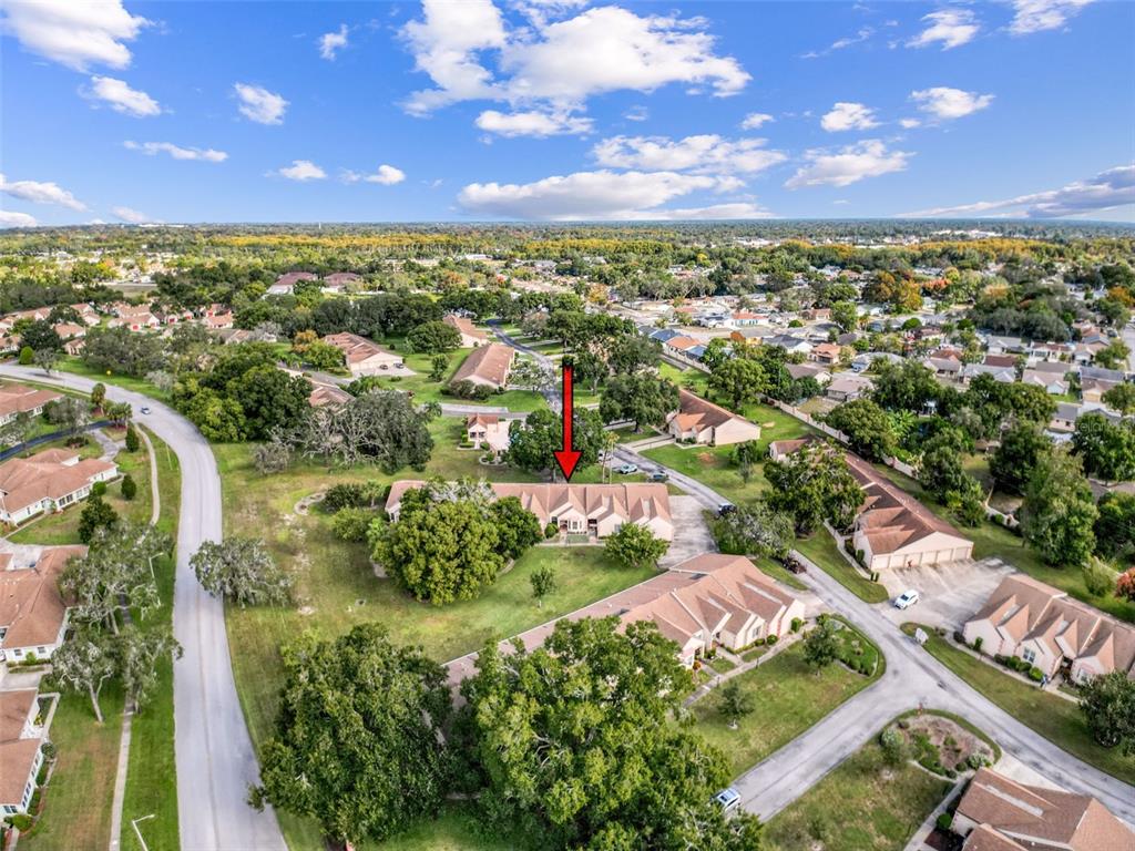 11403 Versailles Lane, Unit E Port Richey, FL 34668 - Photo 62 of 74 an aerial view of residential houses with outdoor space and trees