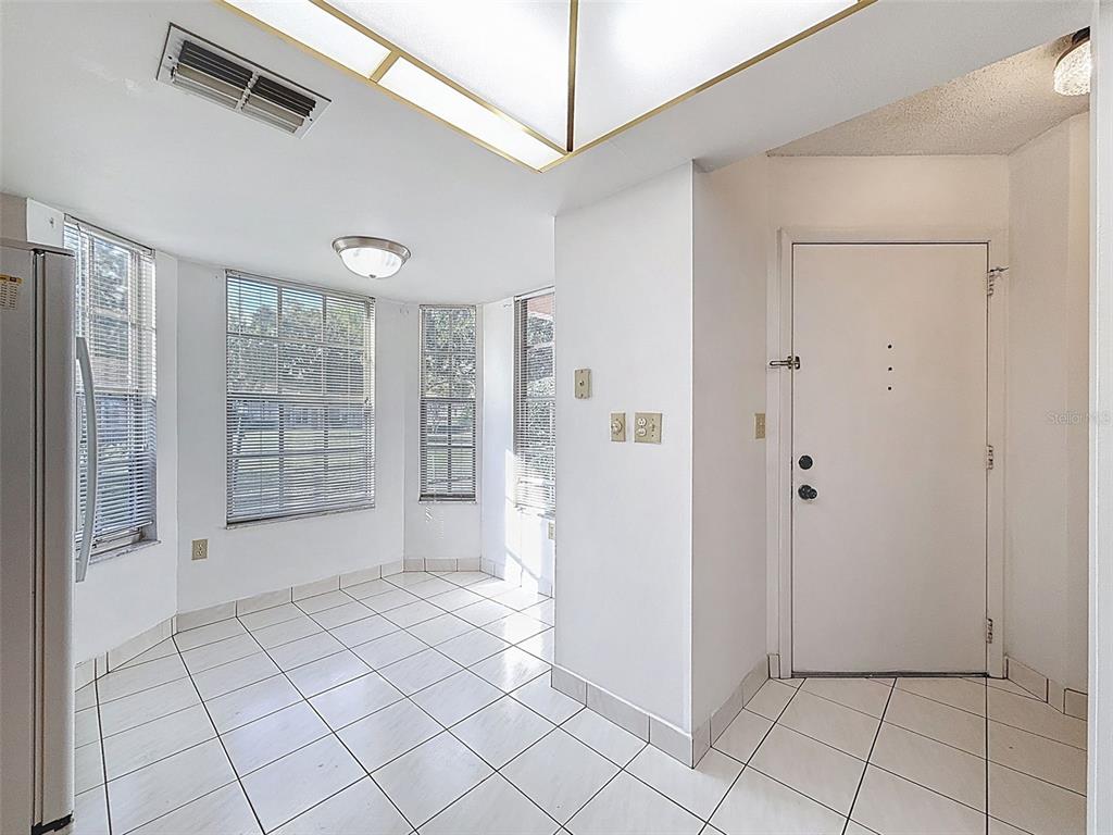 11403 Versailles Lane, Unit E Port Richey, FL 34668 - Photo 7 of 74 a view of an empty room with window and cabinet