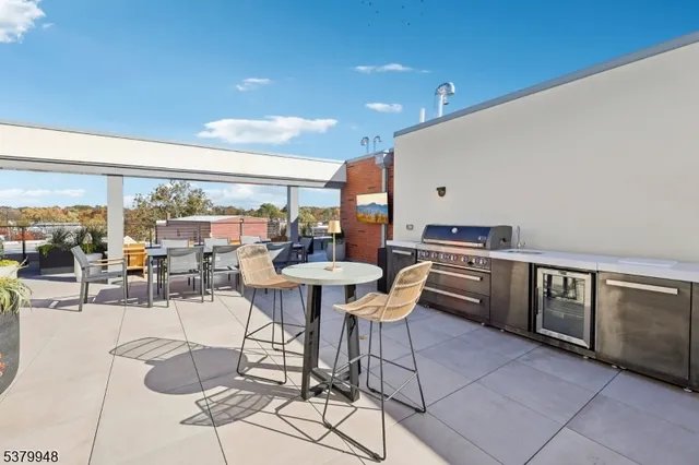 a dining room with furniture and a floor to ceiling window