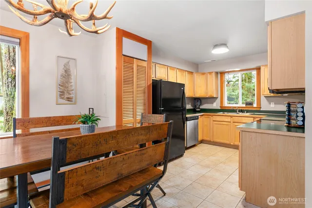 a kitchen with granite countertop a stove a sink and a refrigerator