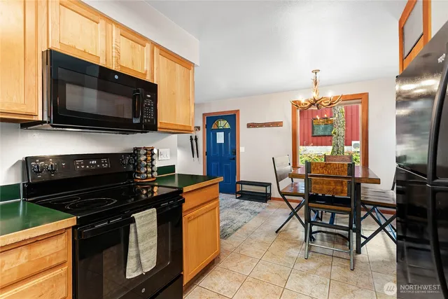 a kitchen with stainless steel appliances a stove a sink a microwave and a refrigerator