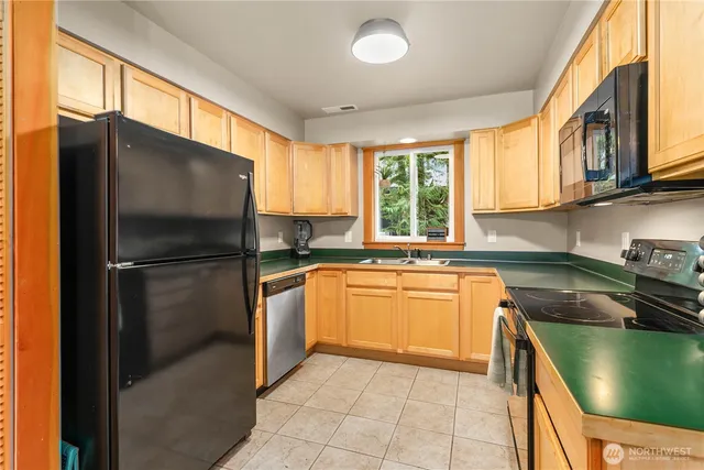 a kitchen with a refrigerator a sink and a stove