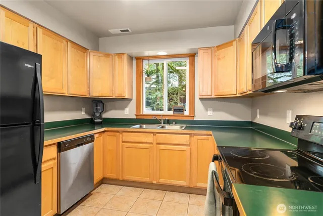 a kitchen with a sink and a stove top oven