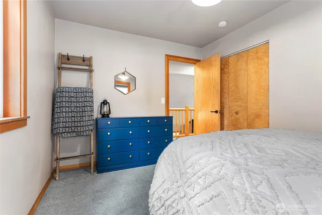 a bedroom with a bed and a dresser