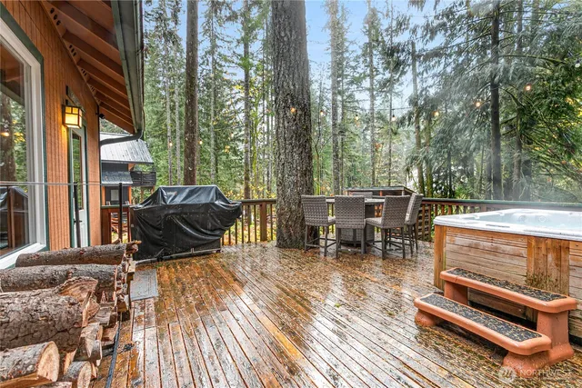 a view of a patio with table and chairs and wooden floor