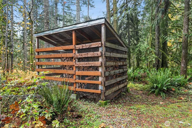 a view of backyard of house with wooden fence