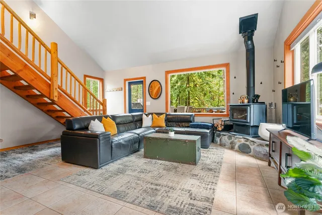 a living room with fireplace furniture and a window
