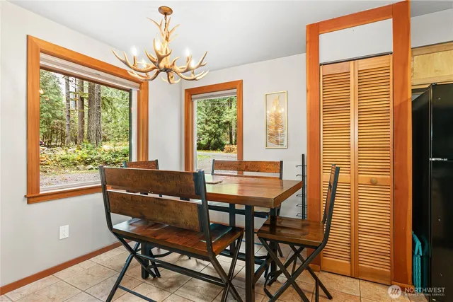 a view of a dining room with furniture a chandelier and wooden floor