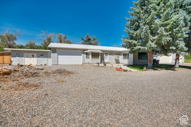 2373 East 190 North Beaver, UT 84713 - Photo 46 of 54 Ranch-style house with driveway, an attached garage, and a metal roof