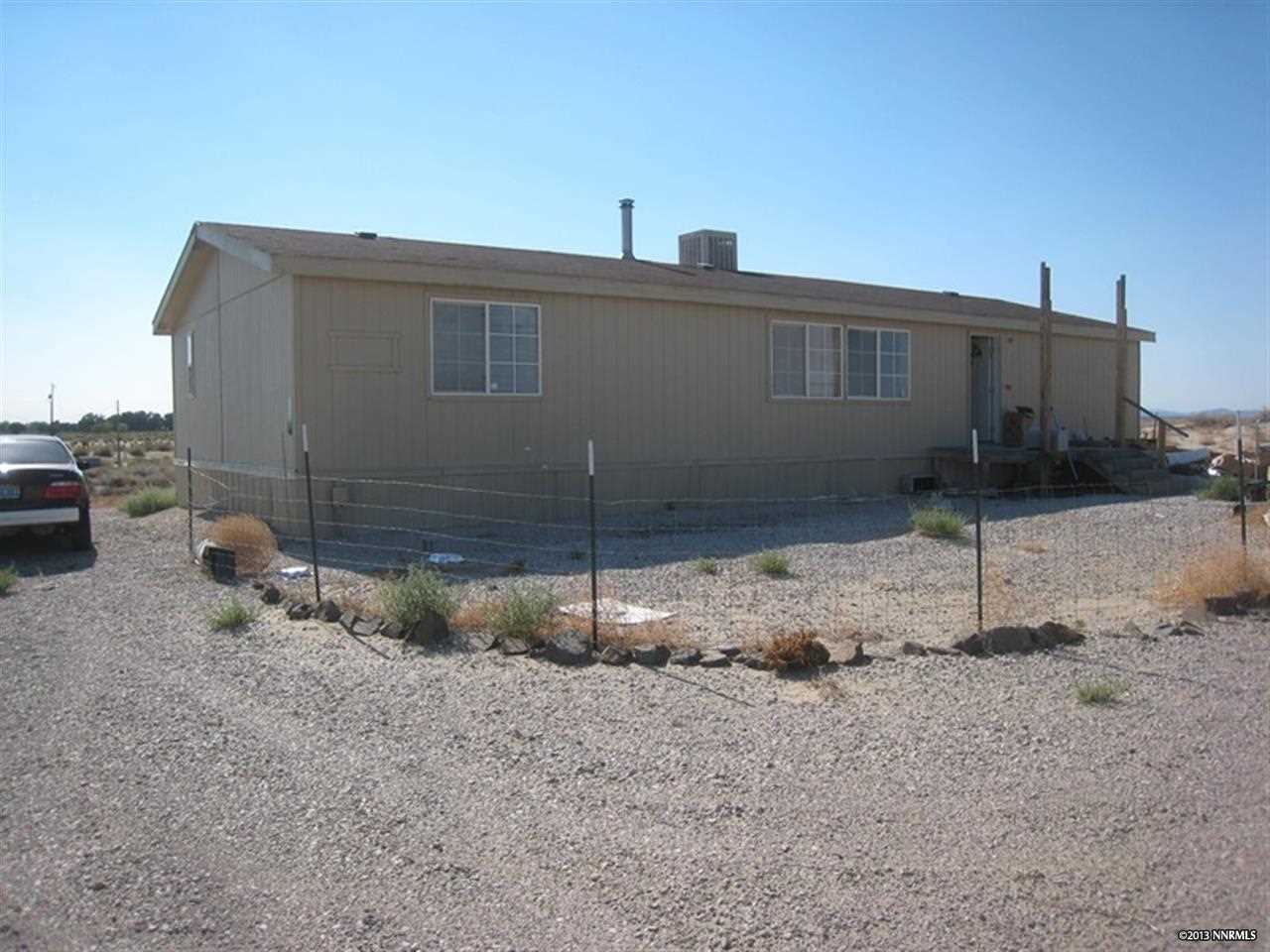 6889 Jacobs Road Fallon, NV 89406 - Photo 1 of 1 a front view of a house with a yard